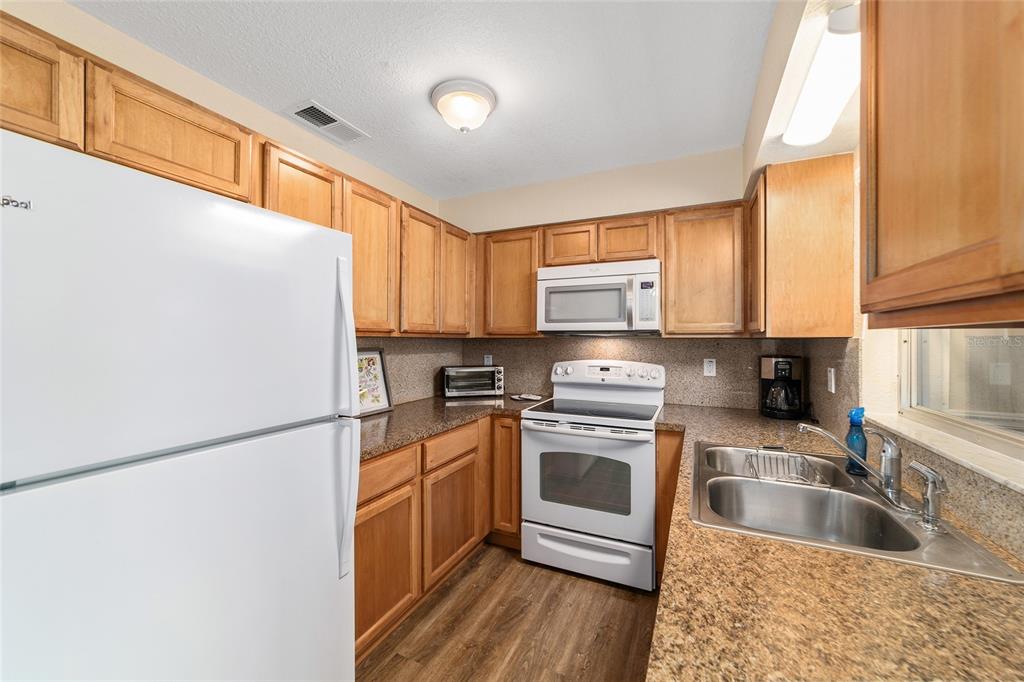 21529 Southwest Honeysuckle Street Dunnellon, FL 34431 - Photo 20 of 55 a kitchen with a refrigerator sink and cabinets