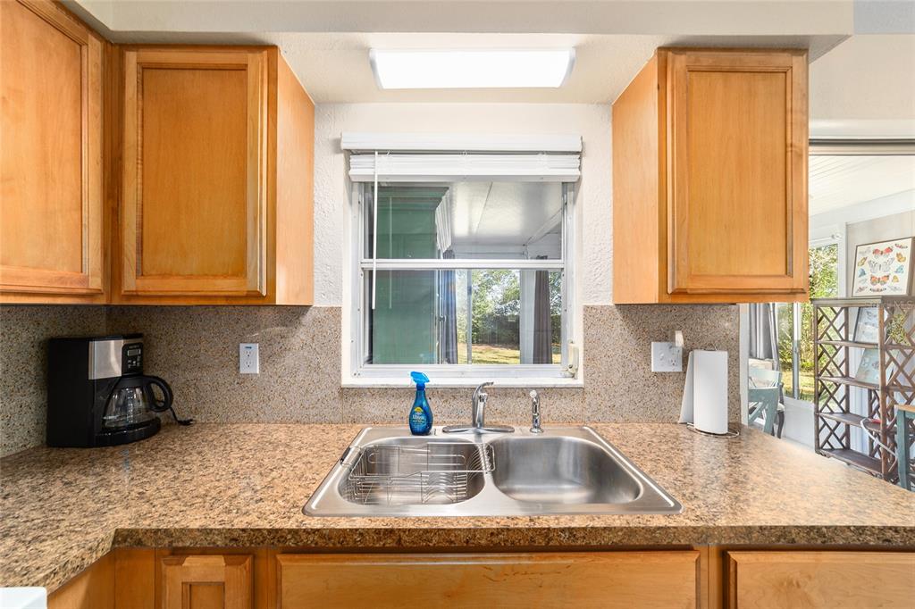 21529 Southwest Honeysuckle Street Dunnellon, FL 34431 - Photo 21 of 55 a kitchen with granite countertop a sink and a window