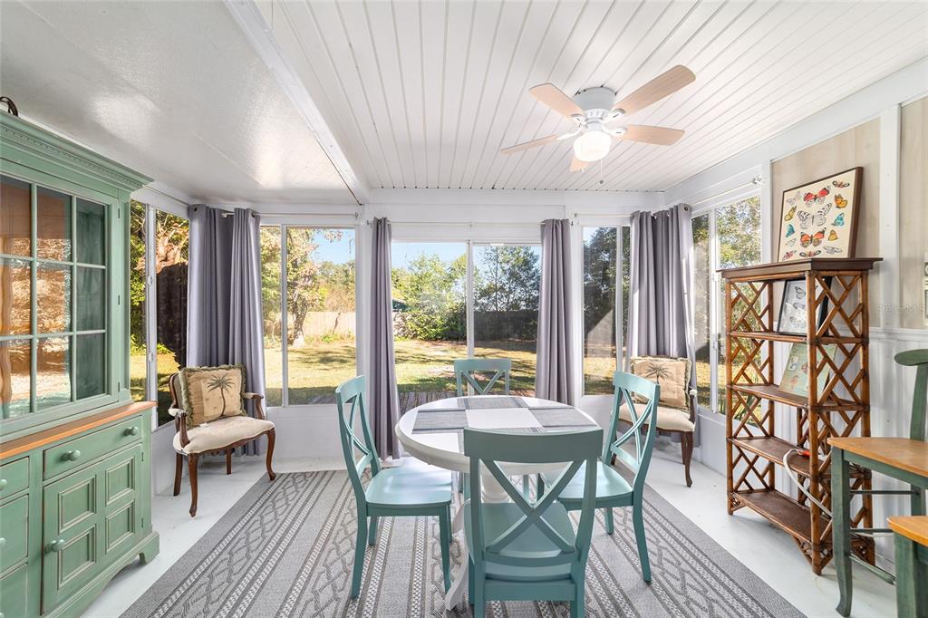 21529 Southwest Honeysuckle Street Dunnellon, FL 34431 - Photo 28 of 55 a view of a dining room with furniture large windows and wooden floor