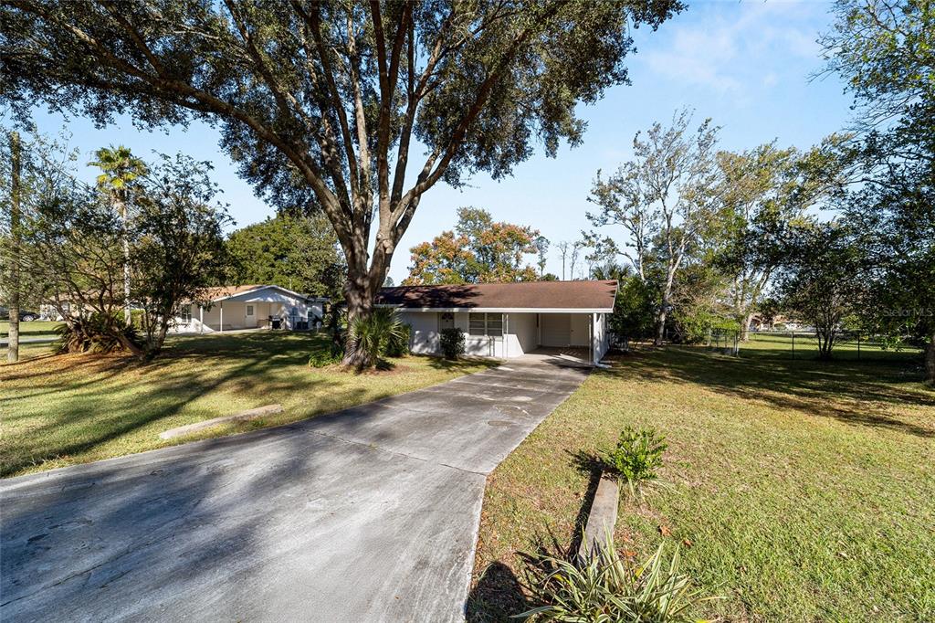 21529 Southwest Honeysuckle Street Dunnellon, FL 34431 - Photo 5 of 55 a front view of a house with a yard and trees