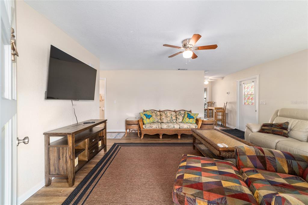 21529 Southwest Honeysuckle Street Dunnellon, FL 34431 - Photo 10 of 55 a living room with furniture and a flat screen tv