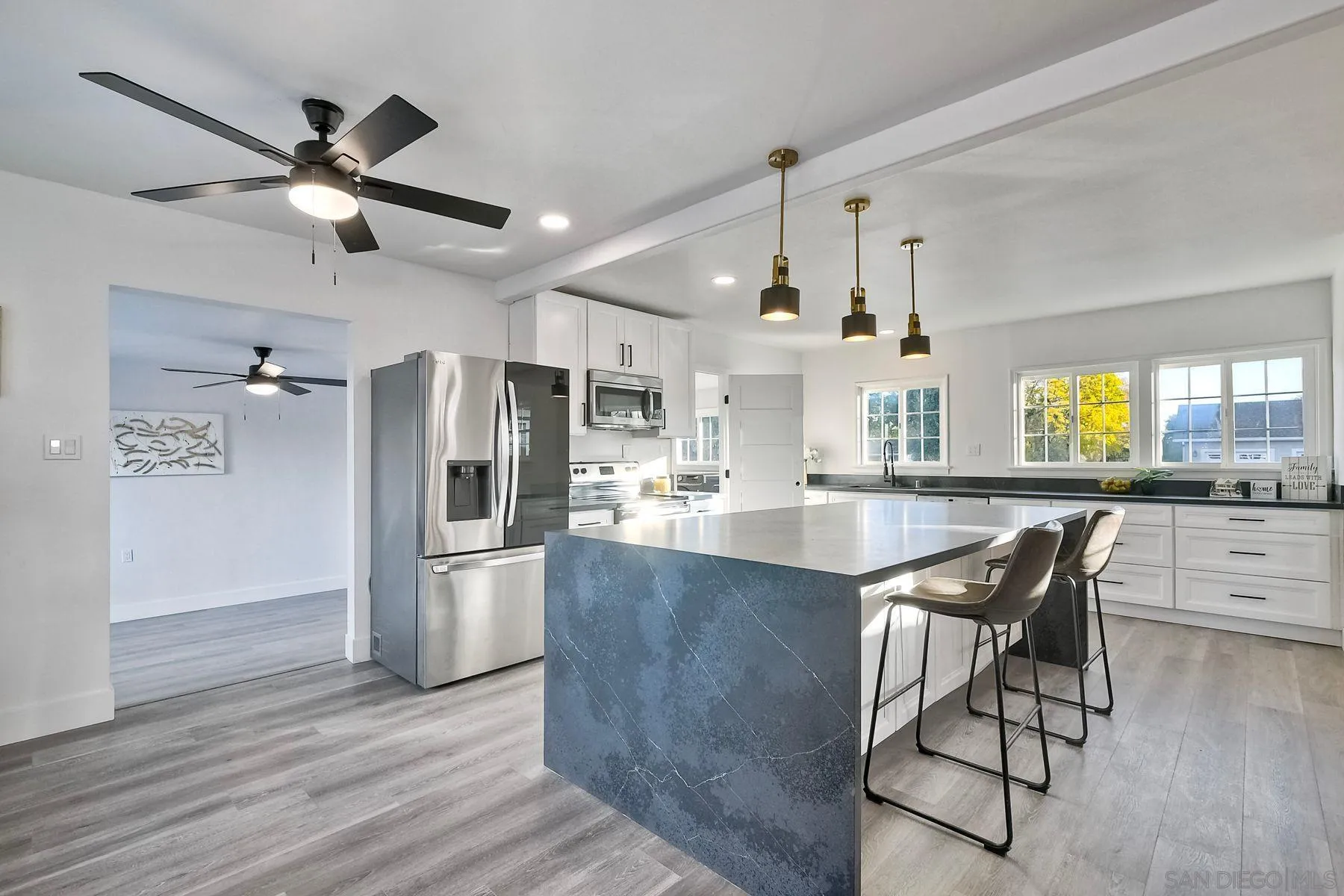 730 Montview Drive Escondido, CA 92025 - Photo 14 of 47 a kitchen with stainless steel appliances kitchen island granite countertop a refrigerator a stove and a wooden floors