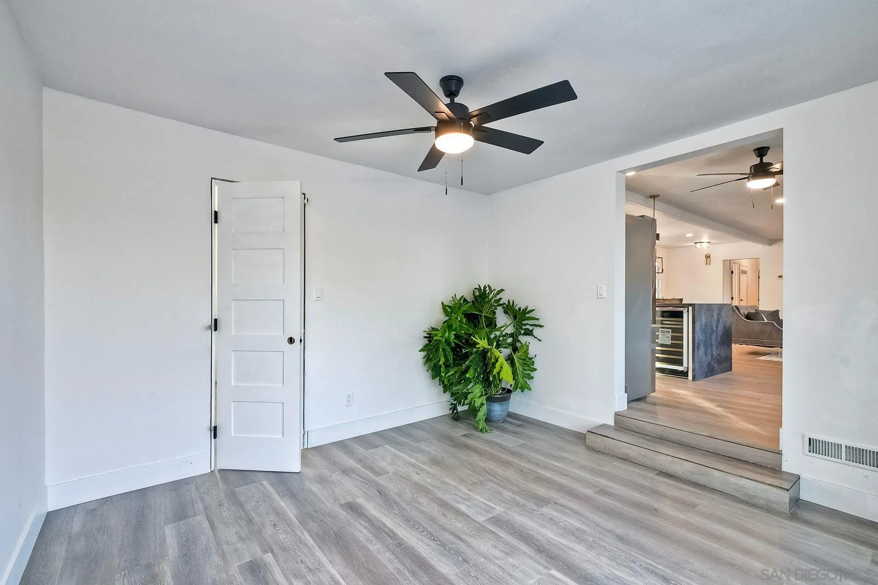 730 Montview Drive Escondido, CA 92025 - Photo 19 of 47 a view of a hallway with wooden floor and a ceiling fan