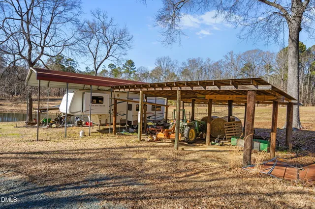 a view of a patio with table and chairs with wooden floor and fence