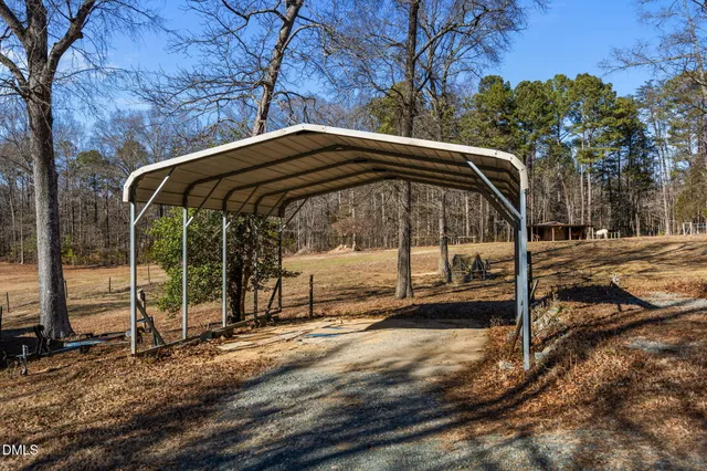 a view of a house with yard and sitting area