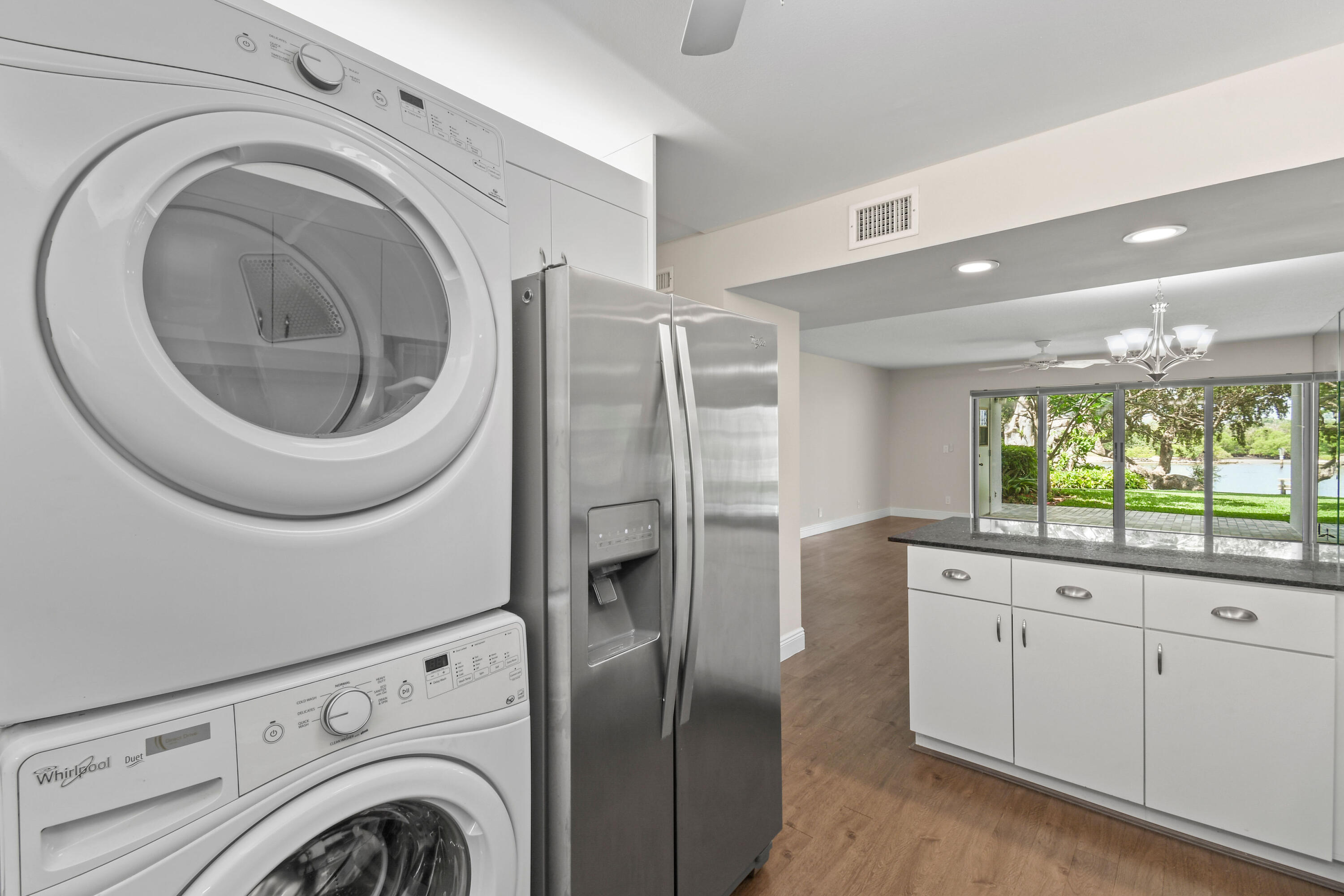 396 Golfview Road, Unit E North Palm Beach, FL 33408 - Photo 11 of 45 a kitchen with stainless steel appliances granite countertop a sink a washer and dryer