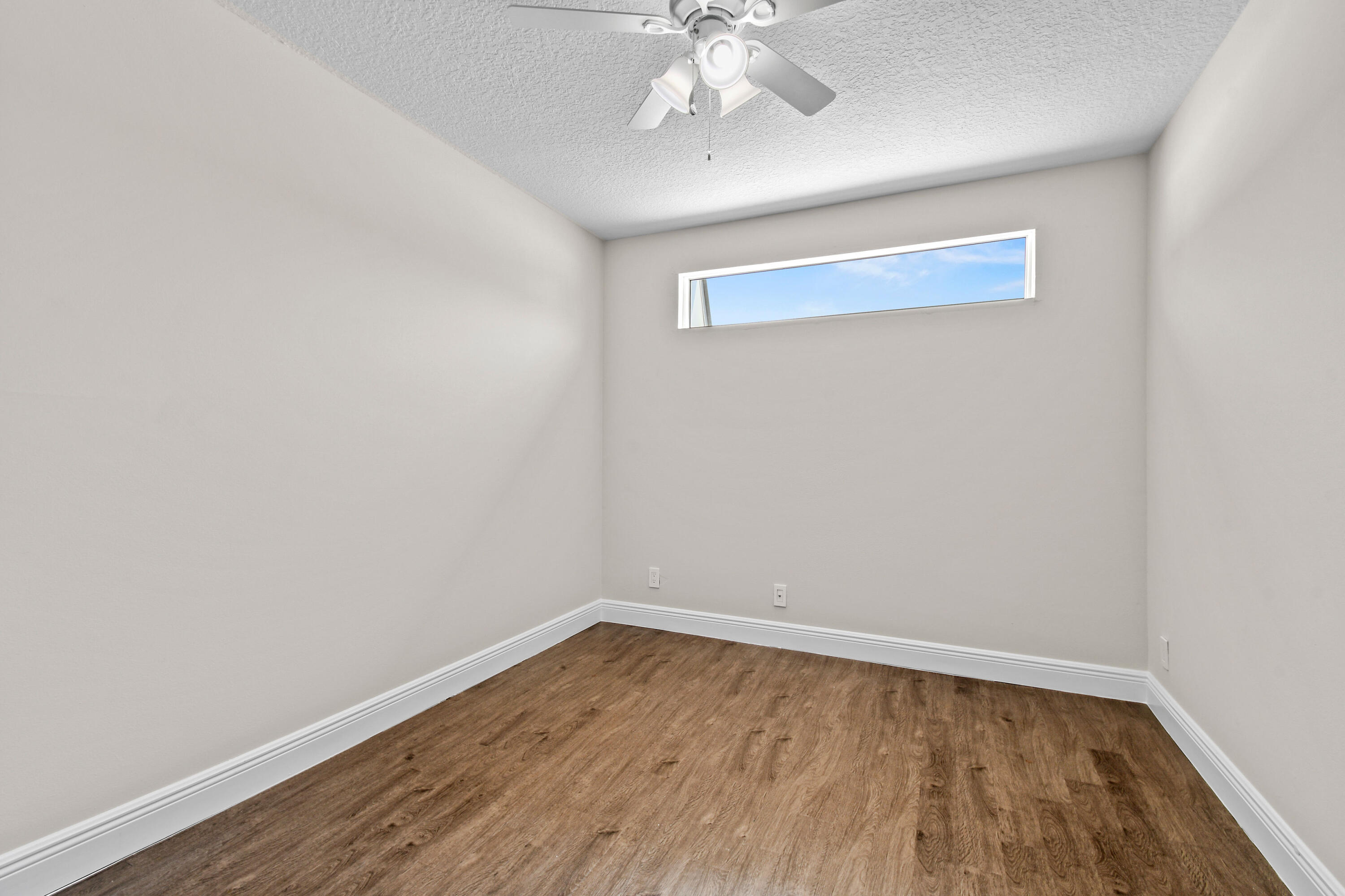 396 Golfview Road, Unit E North Palm Beach, FL 33408 - Photo 17 of 45 a view of an empty room with wooden floor