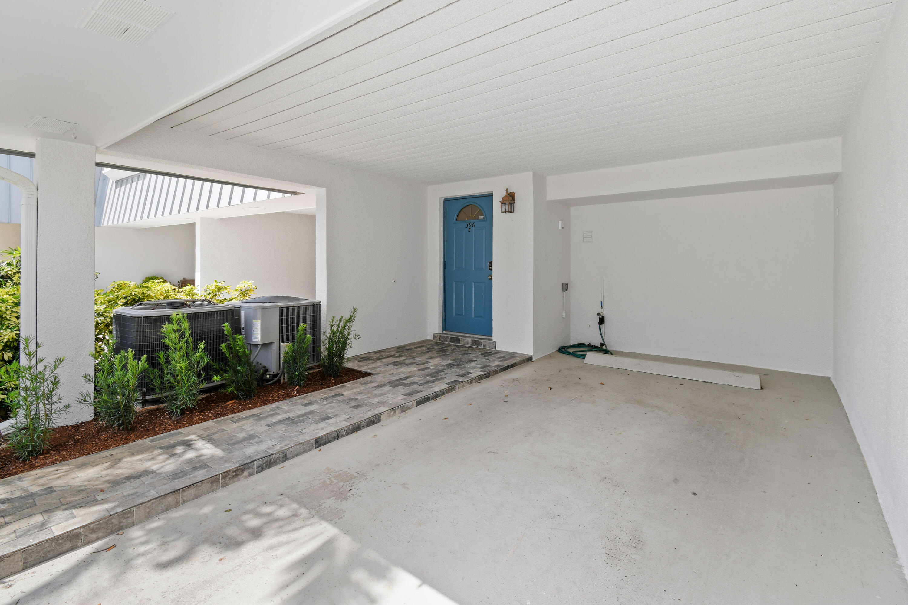 396 Golfview Road, Unit E North Palm Beach, FL 33408 - Photo 2 of 45 a view of a bedroom with furniture and floor to ceiling window