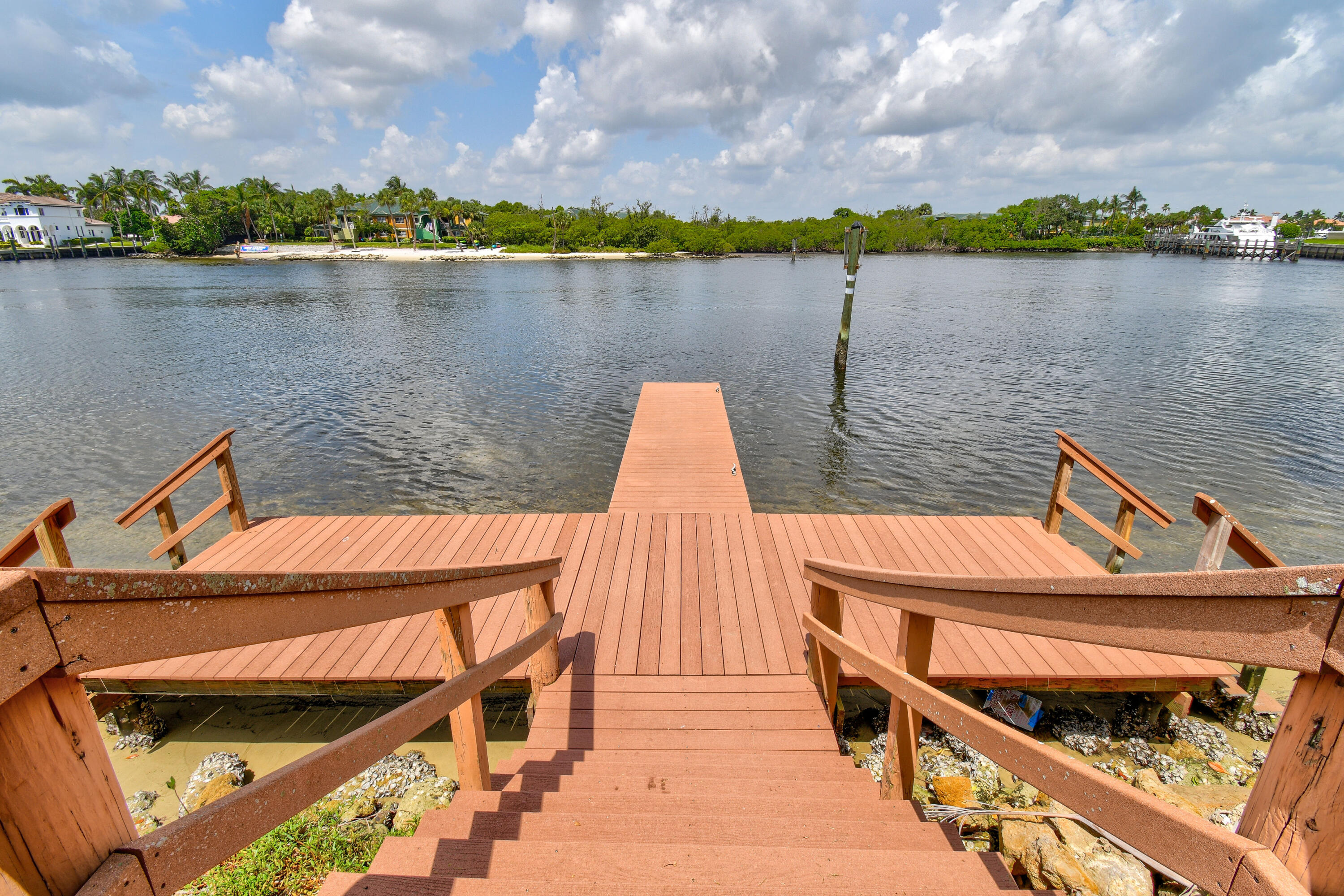 396 Golfview Road, Unit E North Palm Beach, FL 33408 - Photo 29 of 45 a wooden bench sitting next to a lake