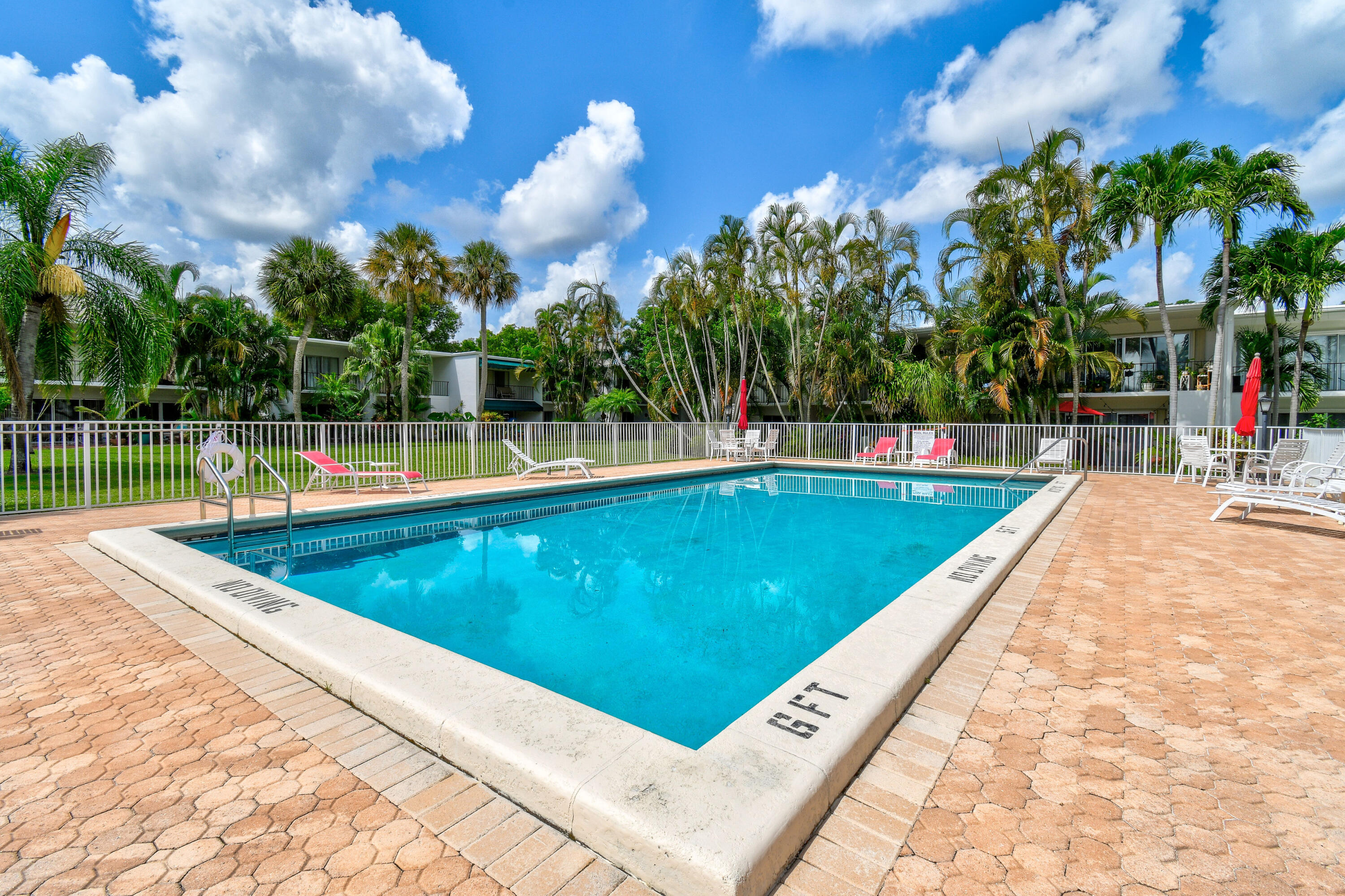 396 Golfview Road, Unit E North Palm Beach, FL 33408 - Photo 32 of 45 swimming pool view with a garden space
