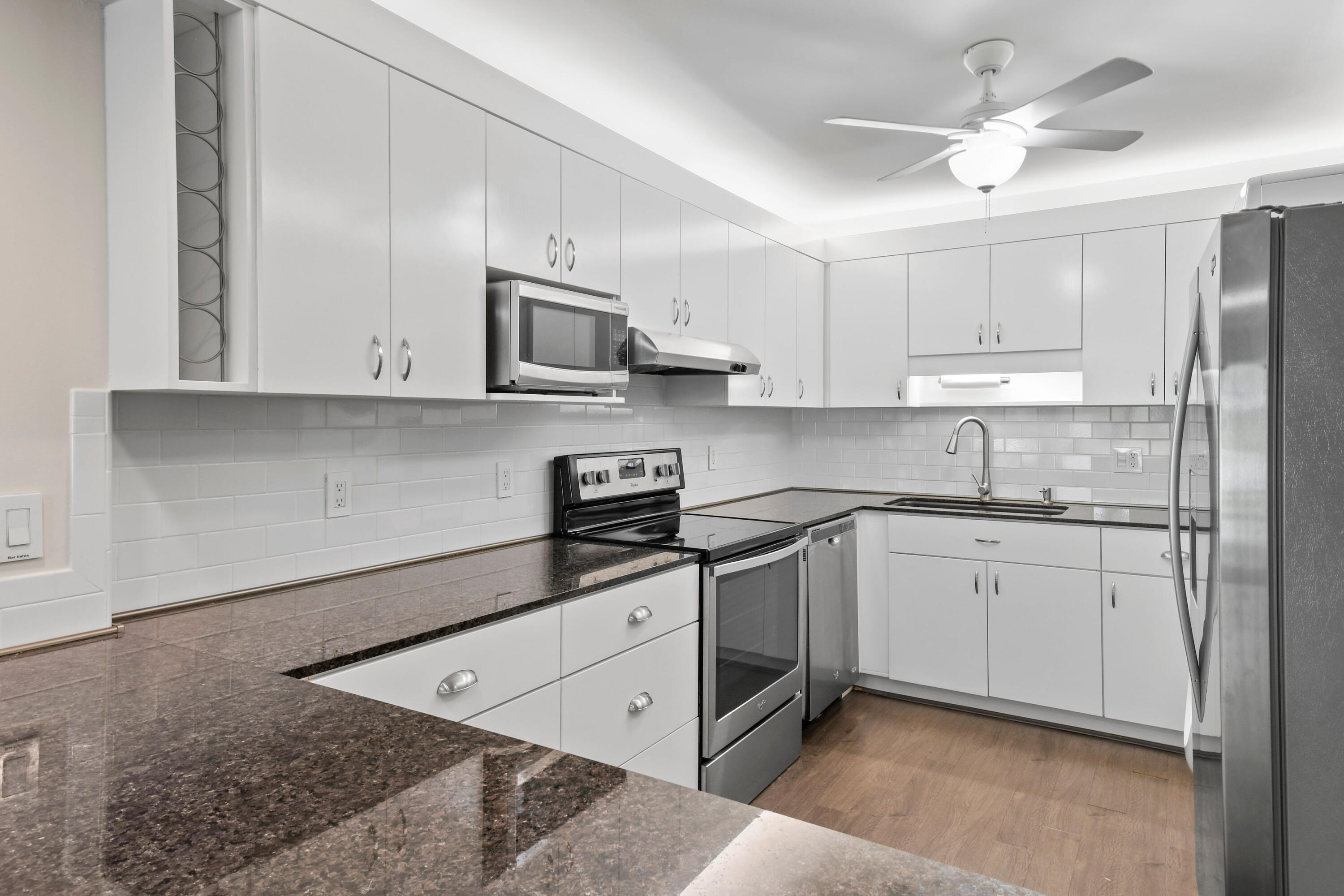 396 Golfview Road, Unit E North Palm Beach, FL 33408 - Photo 8 of 45 a kitchen with stainless steel appliances granite countertop a stove a sink and a refrigerator