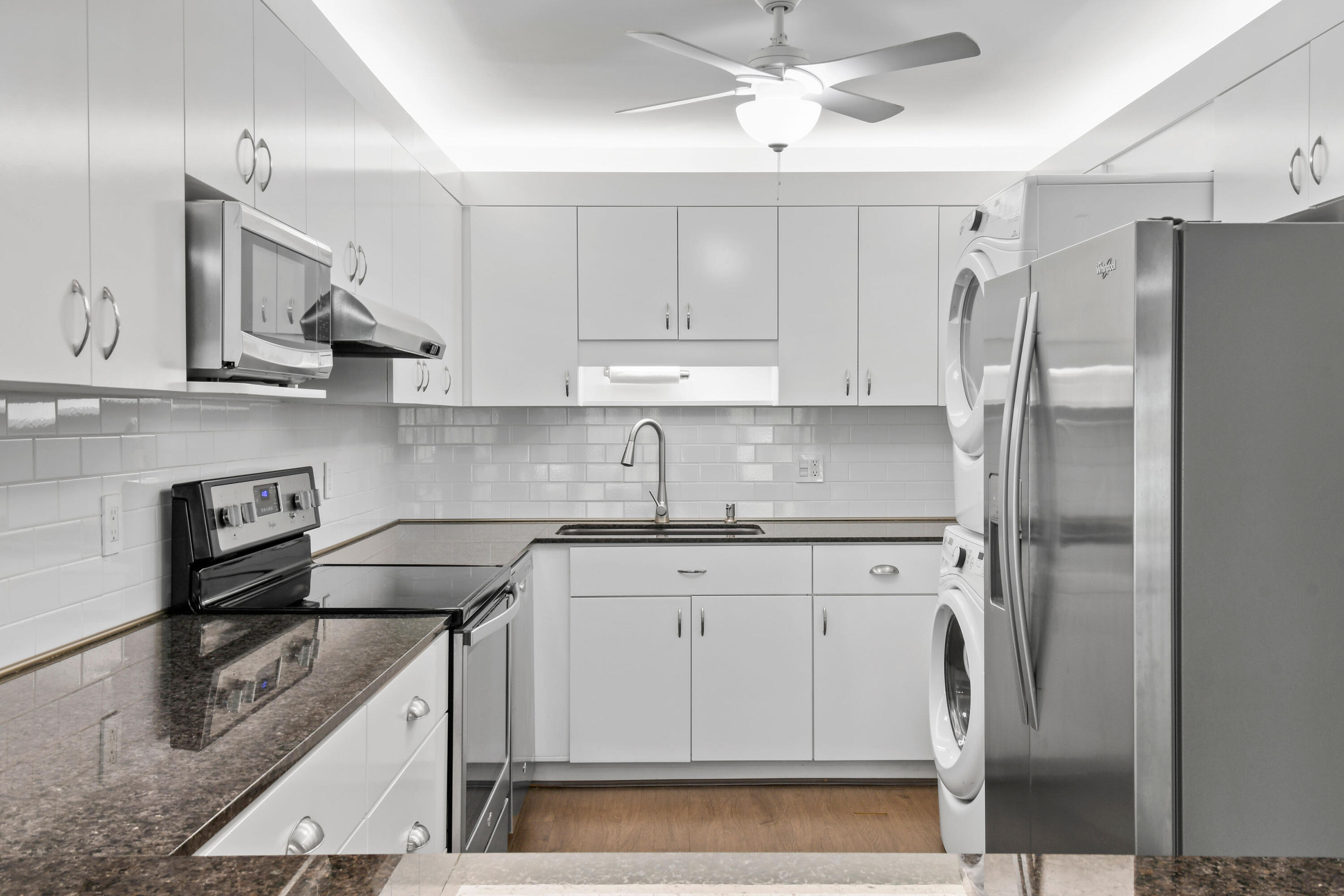 396 Golfview Road, Unit E North Palm Beach, FL 33408 - Photo 9 of 45 a kitchen with stainless steel appliances granite countertop a sink a stove a refrigerator and island