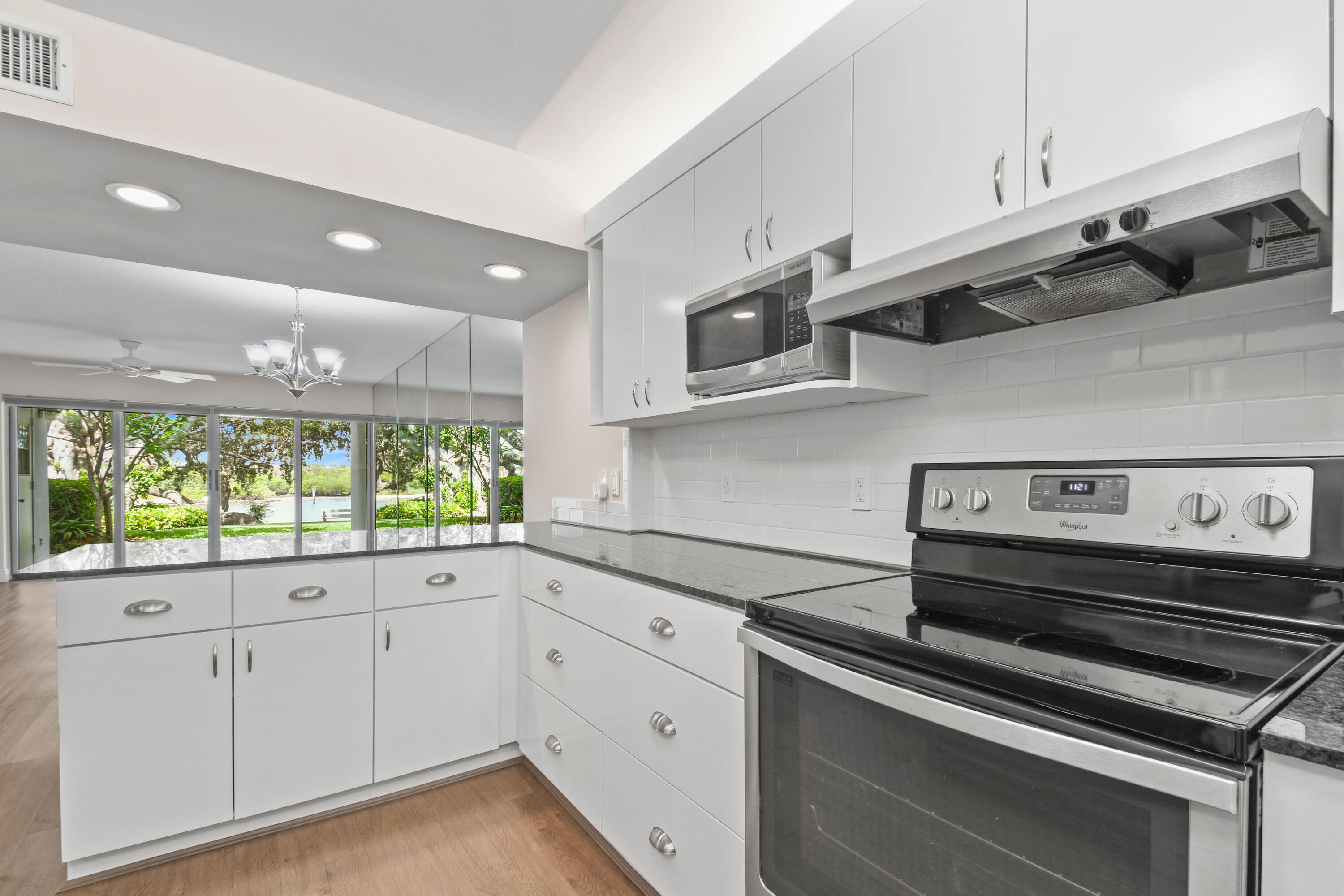 396 Golfview Road, Unit E North Palm Beach, FL 33408 - Photo 10 of 45 a kitchen with appliances cabinets and a window