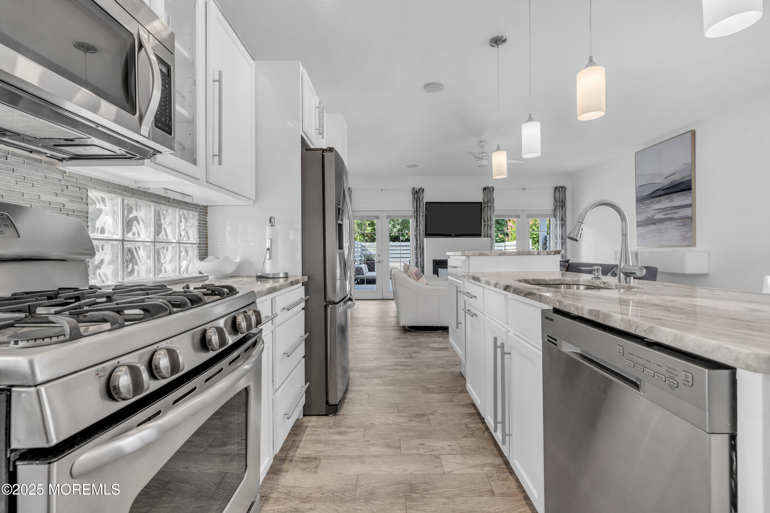 12 Locust Street Highlands, NJ 07732 - Photo 11 of 47 a kitchen with stainless steel appliances a sink stove and cabinets