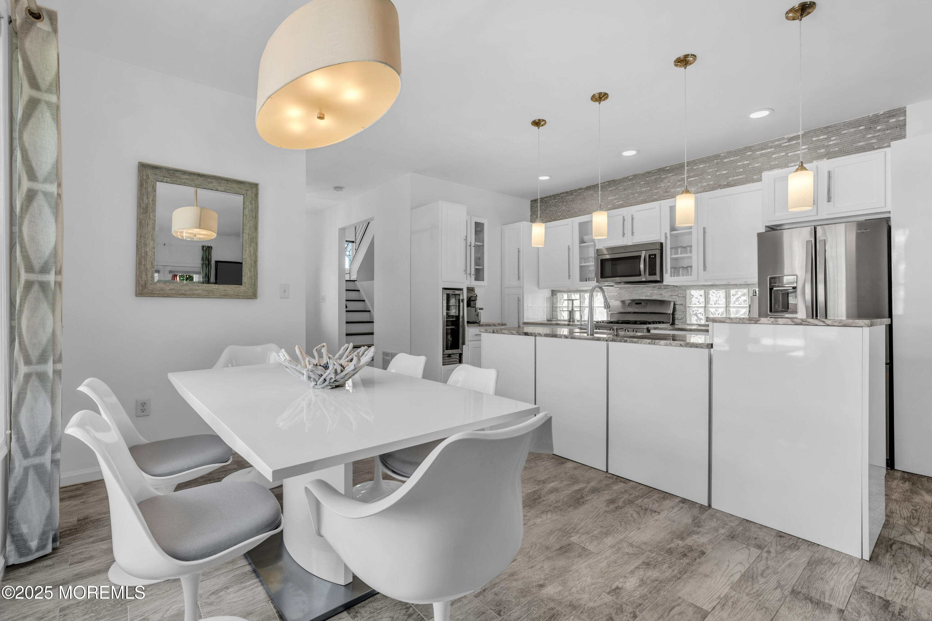 12 Locust Street Highlands, NJ 07732 - Photo 14 of 47 a kitchen with kitchen island a appliances dining table and chairs