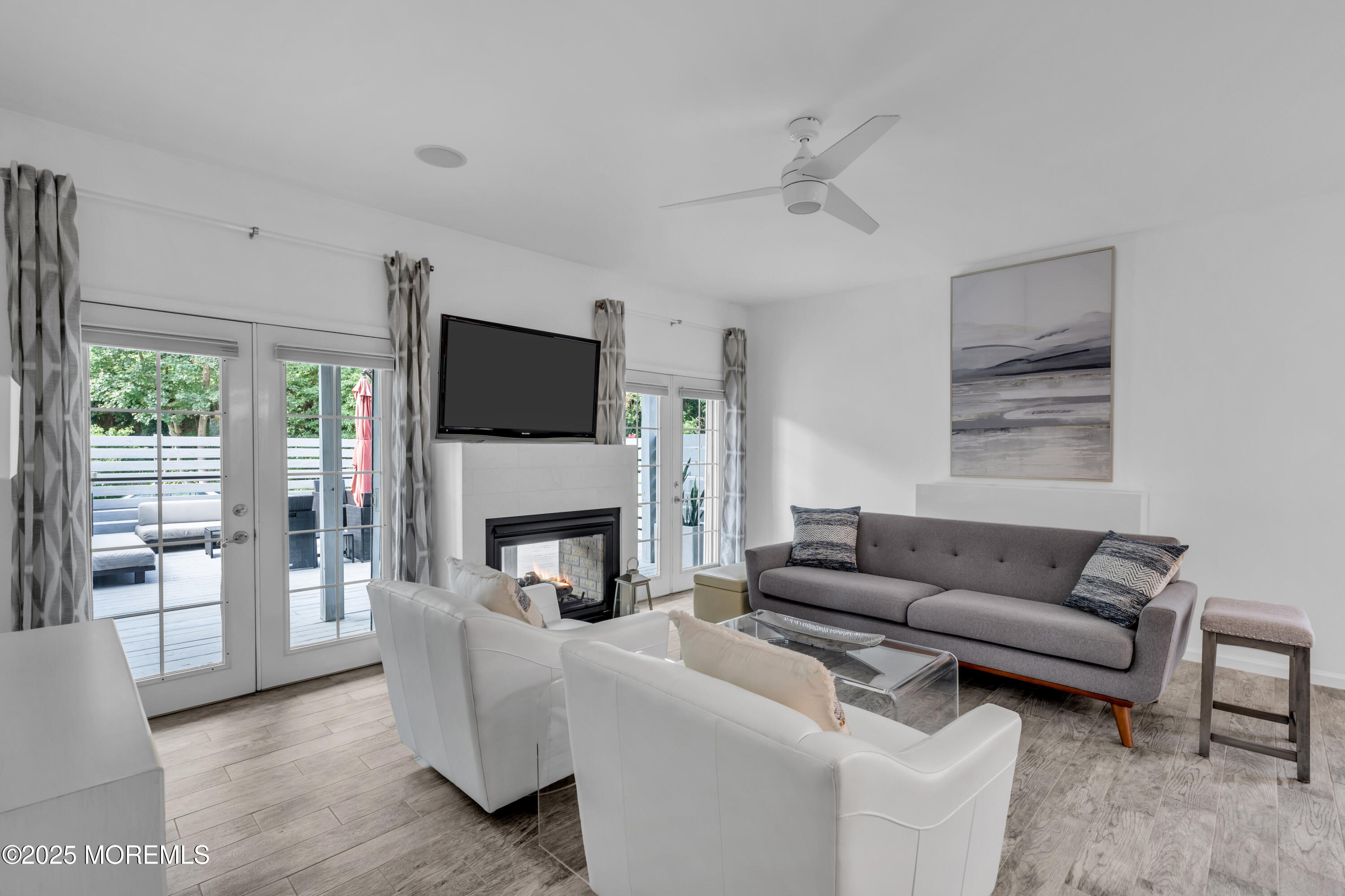 12 Locust Street Highlands, NJ 07732 - Photo 15 of 47 a living room with furniture a flat screen tv and a fireplace