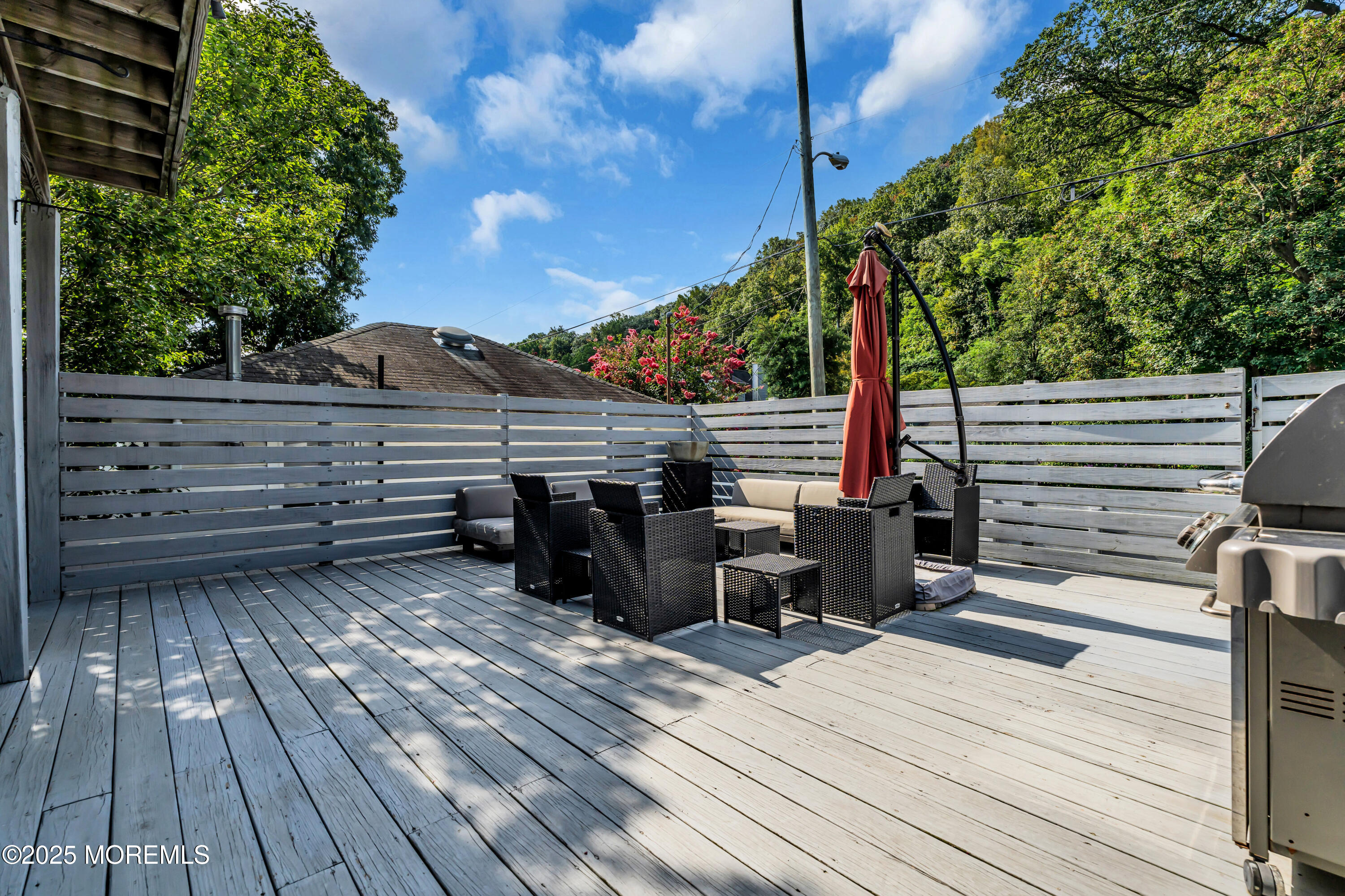 12 Locust Street Highlands, NJ 07732 - Photo 21 of 47 a view of a roof deck with wooden floor and fence