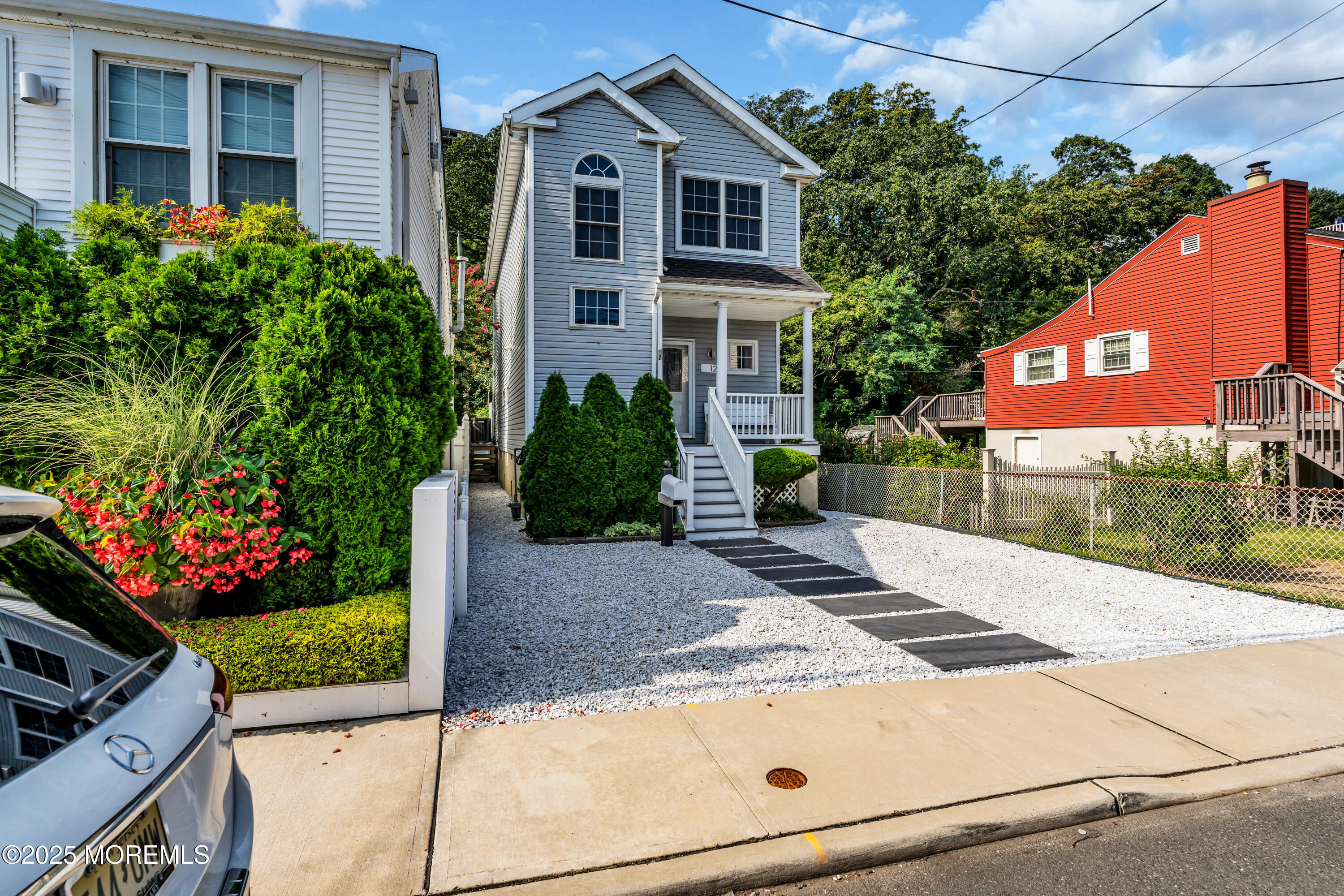 12 Locust Street Highlands, NJ 07732 - Photo 3 of 47 a front view of a house with a yard and potted plants