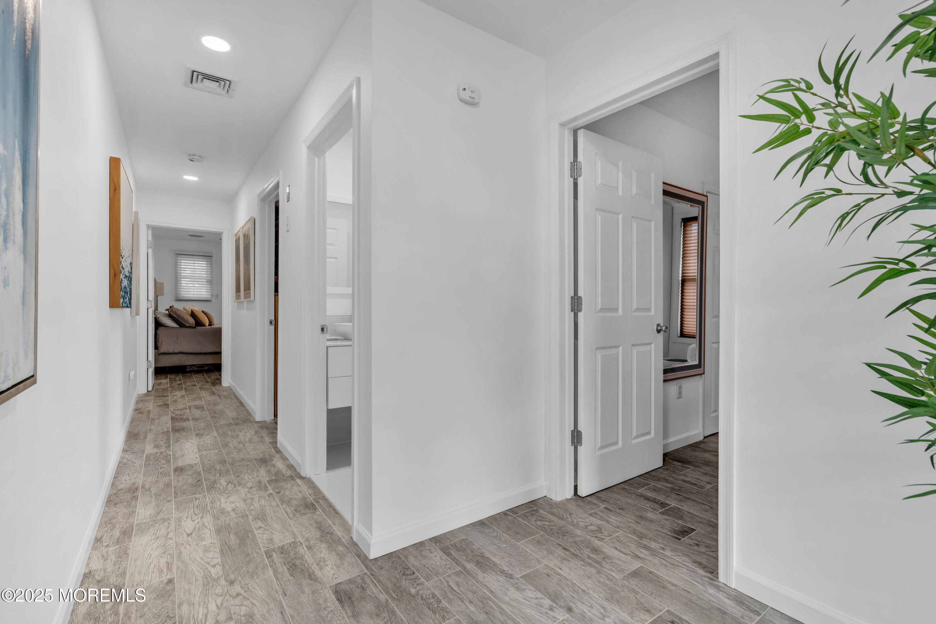 12 Locust Street Highlands, NJ 07732 - Photo 32 of 47 a view of a hallway with wooden floor and a potted plant