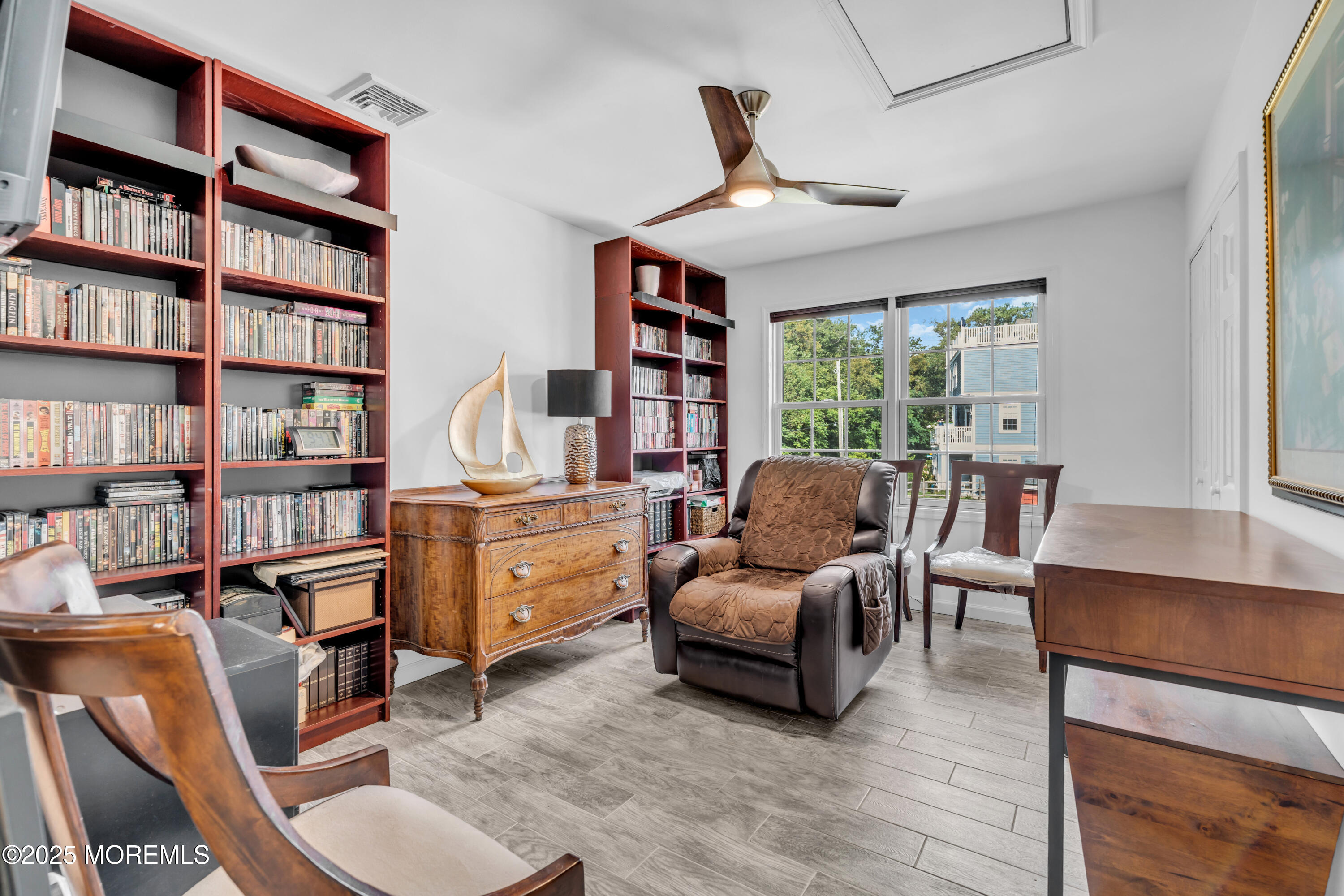 12 Locust Street Highlands, NJ 07732 - Photo 33 of 47 a living room with fireplace furniture and a book shelf