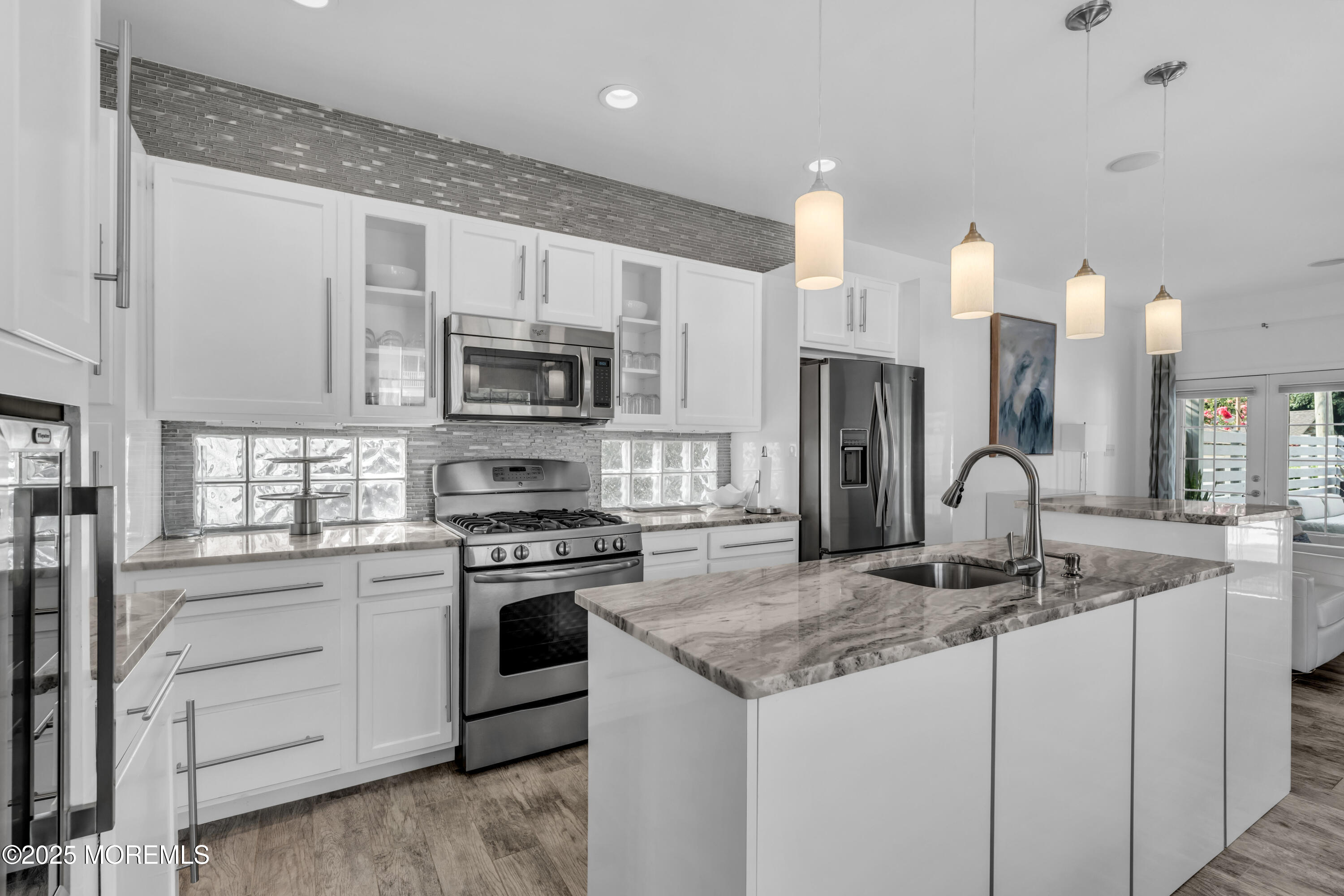 12 Locust Street Highlands, NJ 07732 - Photo 7 of 47 a kitchen with granite countertop a sink and stainless steel appliances