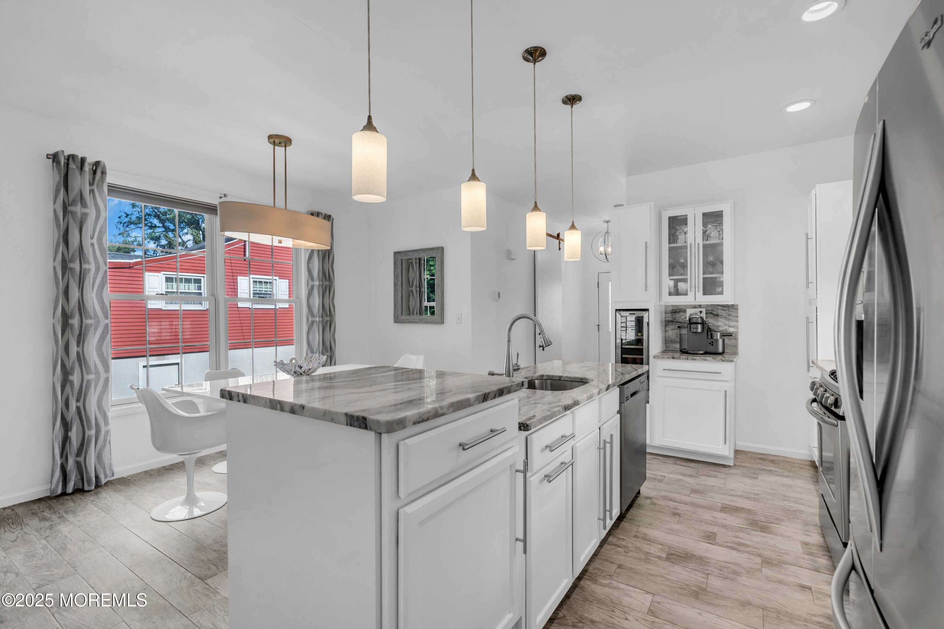 12 Locust Street Highlands, NJ 07732 - Photo 9 of 47 a kitchen with stainless steel appliances granite countertop a sink a counter space and cabinets