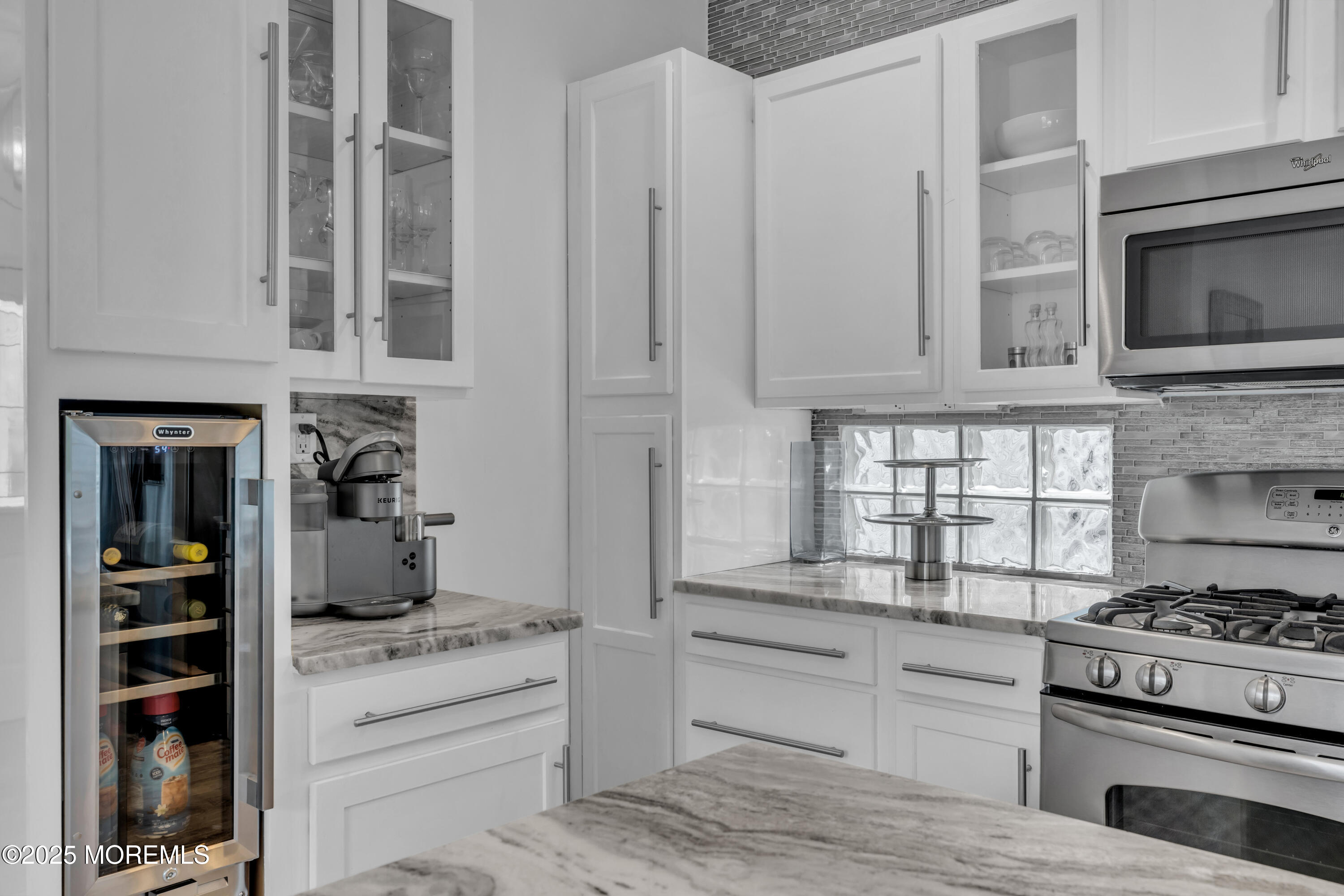 12 Locust Street Highlands, NJ 07732 - Photo 10 of 47 a kitchen with white cabinets and appliances