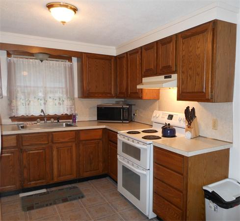 29 Stafford Road Monson, MA 01057 - Photo 2 of 14 a kitchen with a stove top oven sink and cabinets