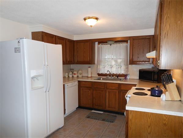 29 Stafford Road Monson, MA 01057 - Photo 3 of 14 a kitchen with a refrigerator and a stove top oven
