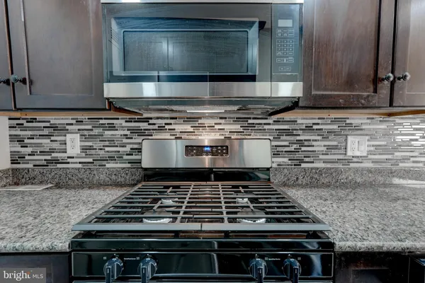 a stove top oven sitting inside of a kitchen