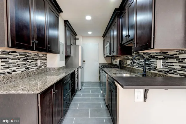 a kitchen with stainless steel appliances granite countertop counter space a sink and cabinets