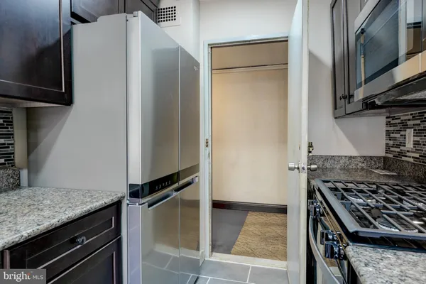 a kitchen with a stove and a refrigerator