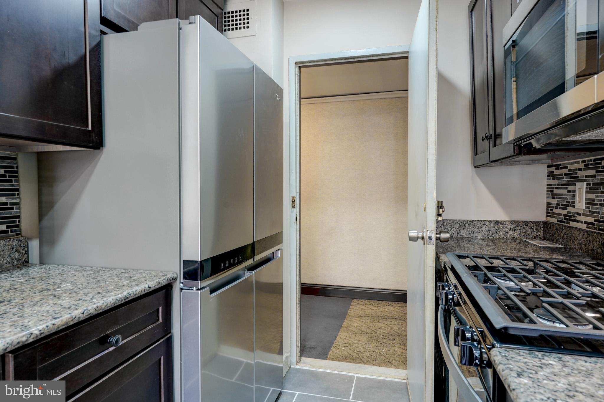1900 Lyttonsville Road, Unit 211 Silver Spring, MD 20910 - Photo 17 of 46 a kitchen with a stove and a refrigerator