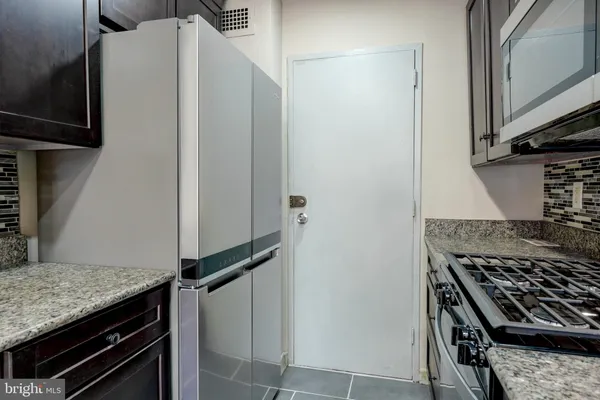 a kitchen with a stove and a refrigerator