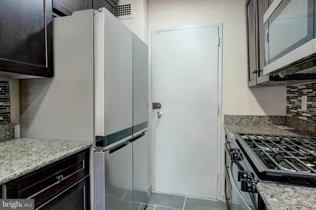 a kitchen with a stove and a refrigerator