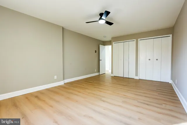 a view of empty room with wooden floor