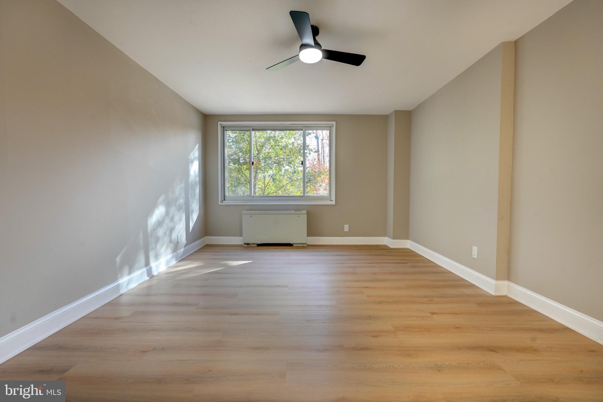 1900 Lyttonsville Road, Unit 211 Silver Spring, MD 20910 - Photo 24 of 46 wooden floor in an empty room with a window