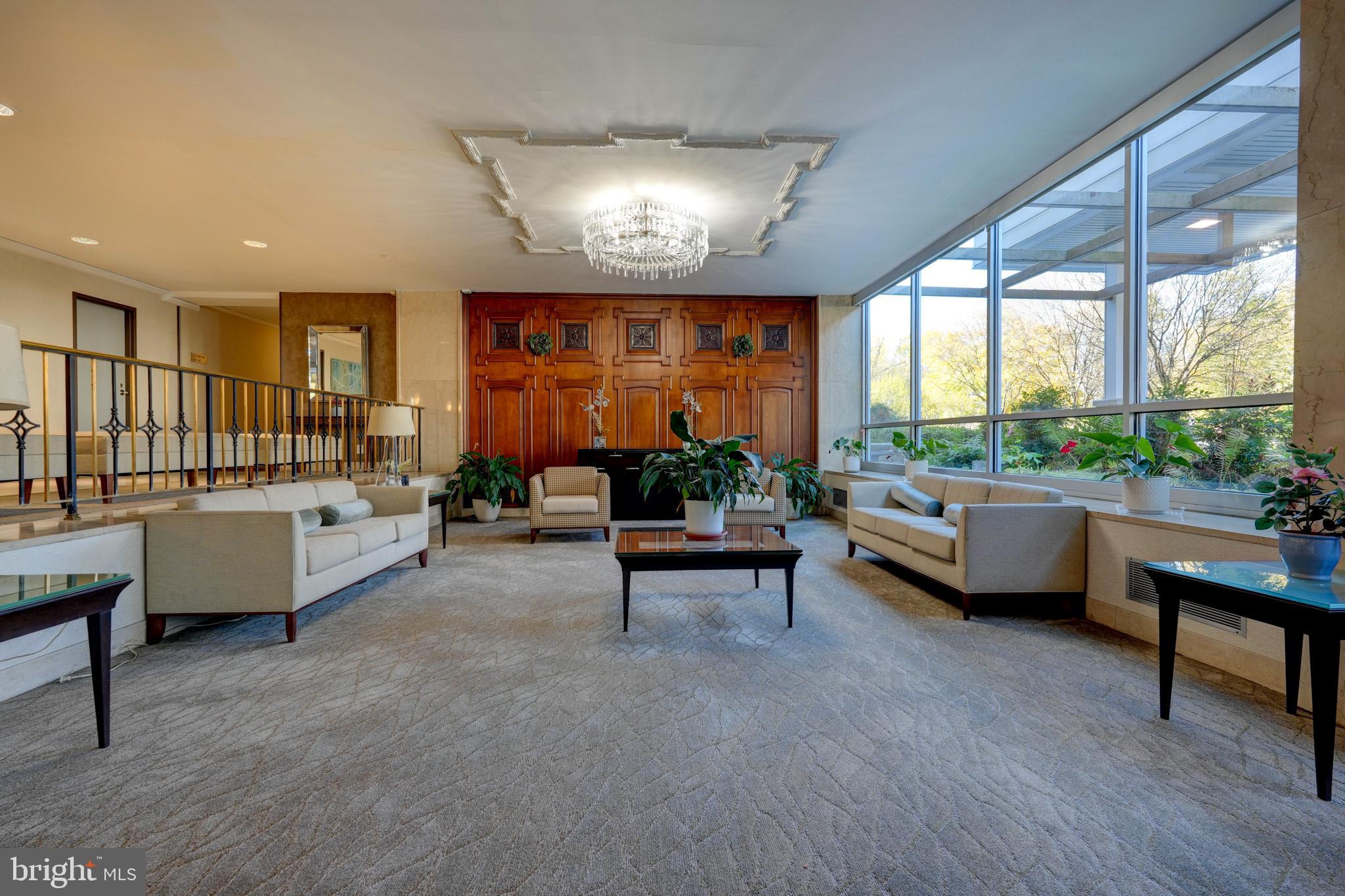 1900 Lyttonsville Road, Unit 211 Silver Spring, MD 20910 - Photo 33 of 46 a living room with furniture and a large window