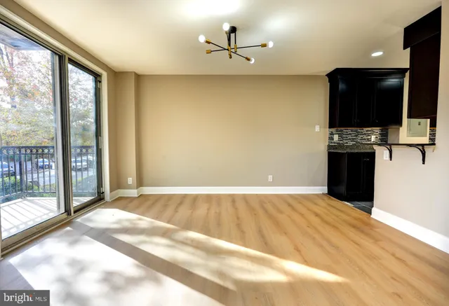 a view of a kitchen with a sink and a refrigerator