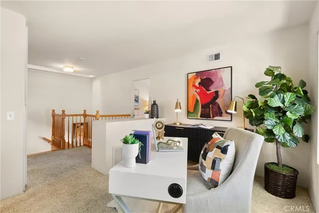 a living room with furniture and potted plant