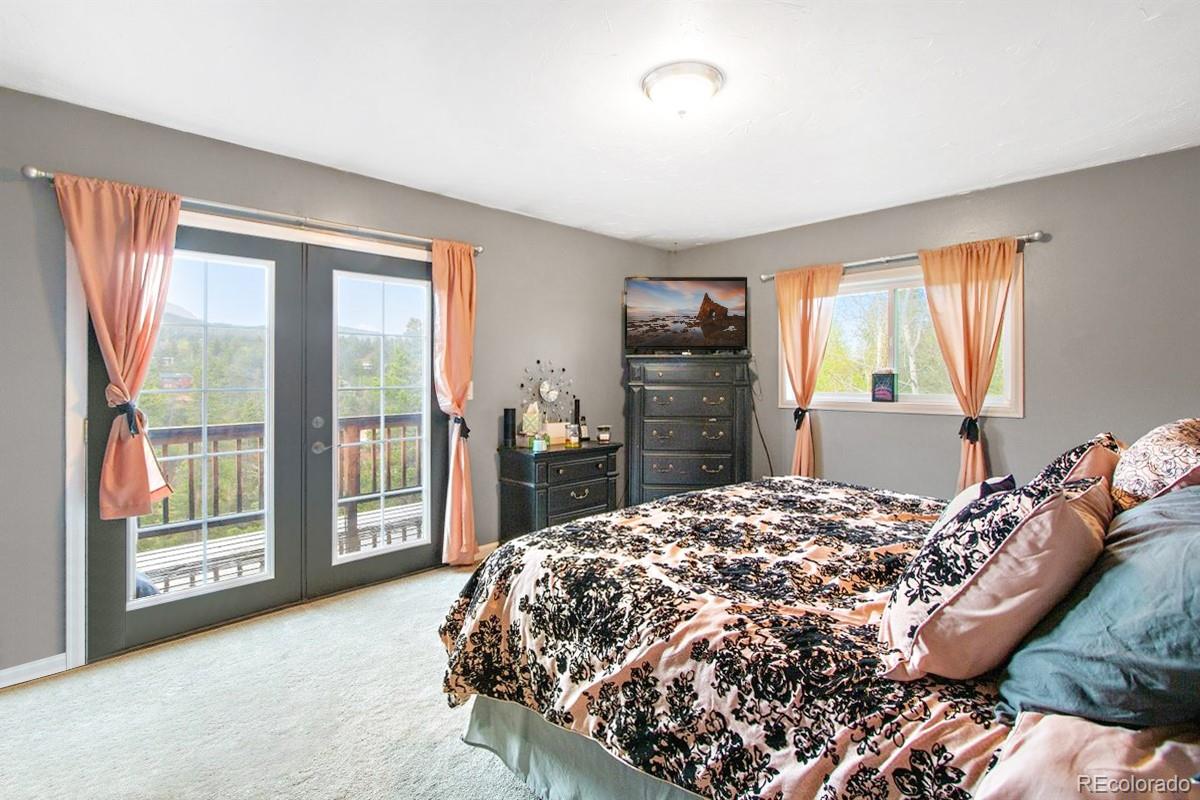 191 Renaud Road Bailey, CO 80421 - Photo 13 of 28 a bed sitting in a bedroom next to a window