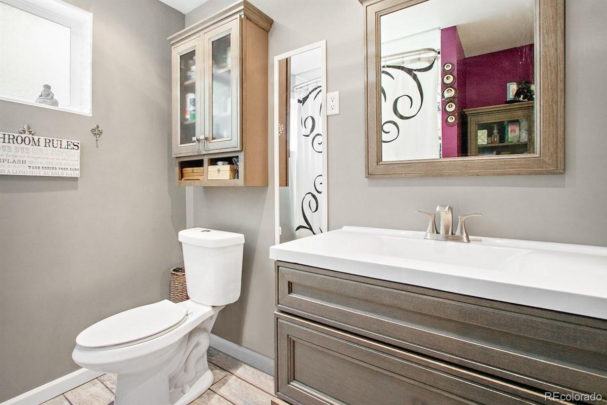 191 Renaud Road Bailey, CO 80421 - Photo 14 of 28 a white toilet sitting next to a bathroom sink