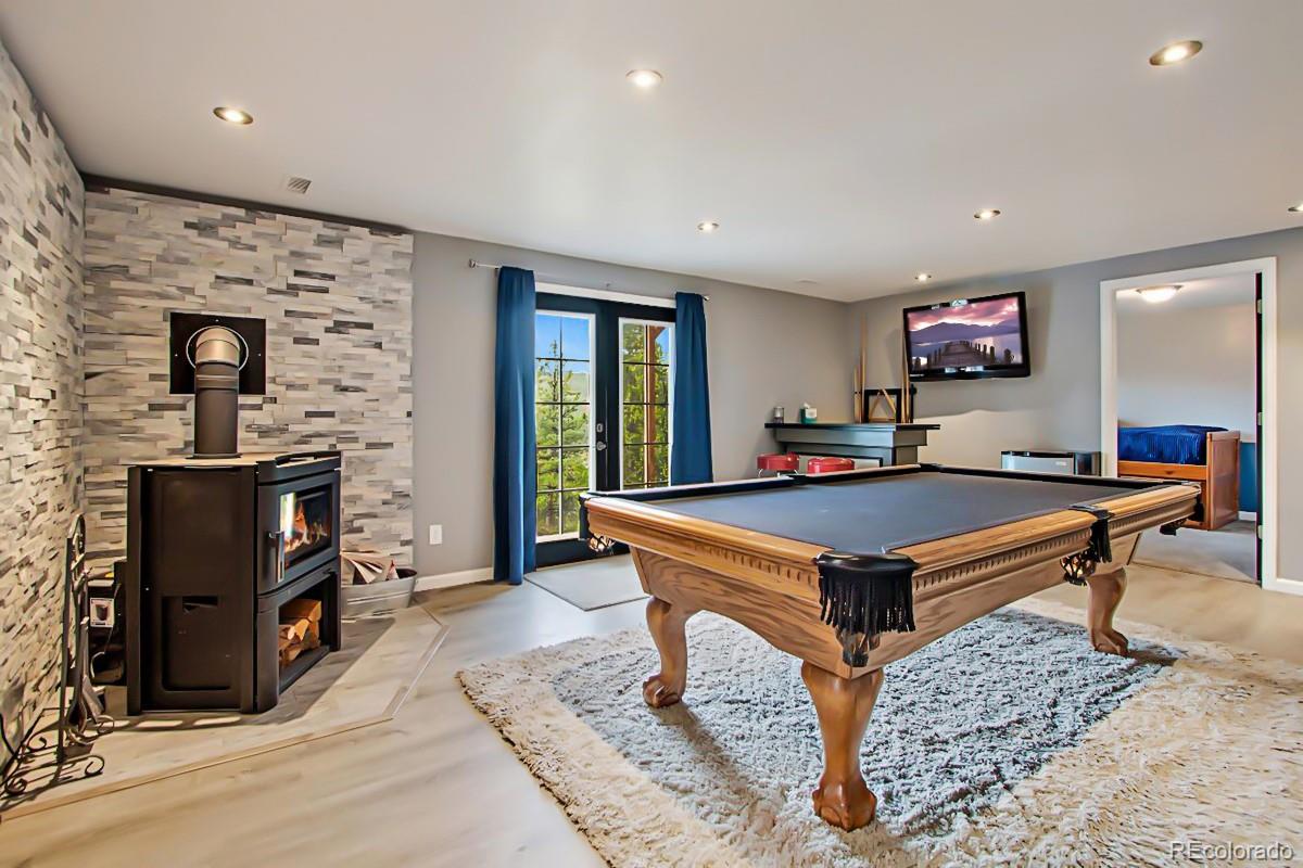 191 Renaud Road Bailey, CO 80421 - Photo 15 of 28 a living room with a table and a flat screen tv