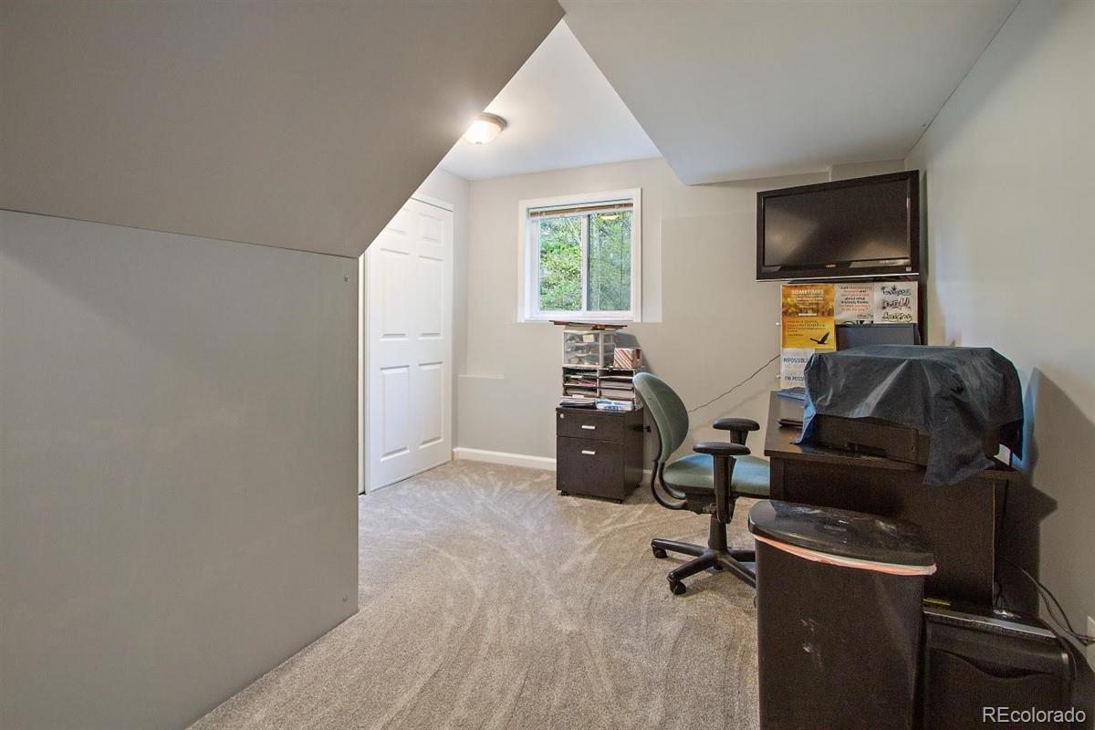 191 Renaud Road Bailey, CO 80421 - Photo 21 of 28 a room with furniture and a flat screen tv