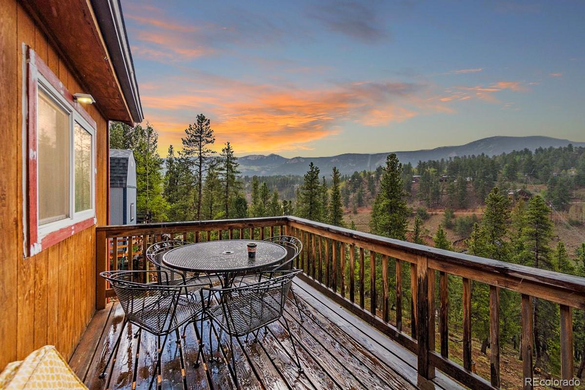 191 Renaud Road Bailey, CO 80421 - Photo 3 of 28 a view of a balcony with a table and chairs
