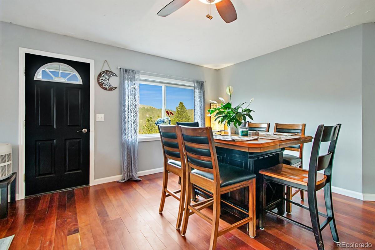 191 Renaud Road Bailey, CO 80421 - Photo 6 of 28 a view of a dining room with furniture and wooden floor