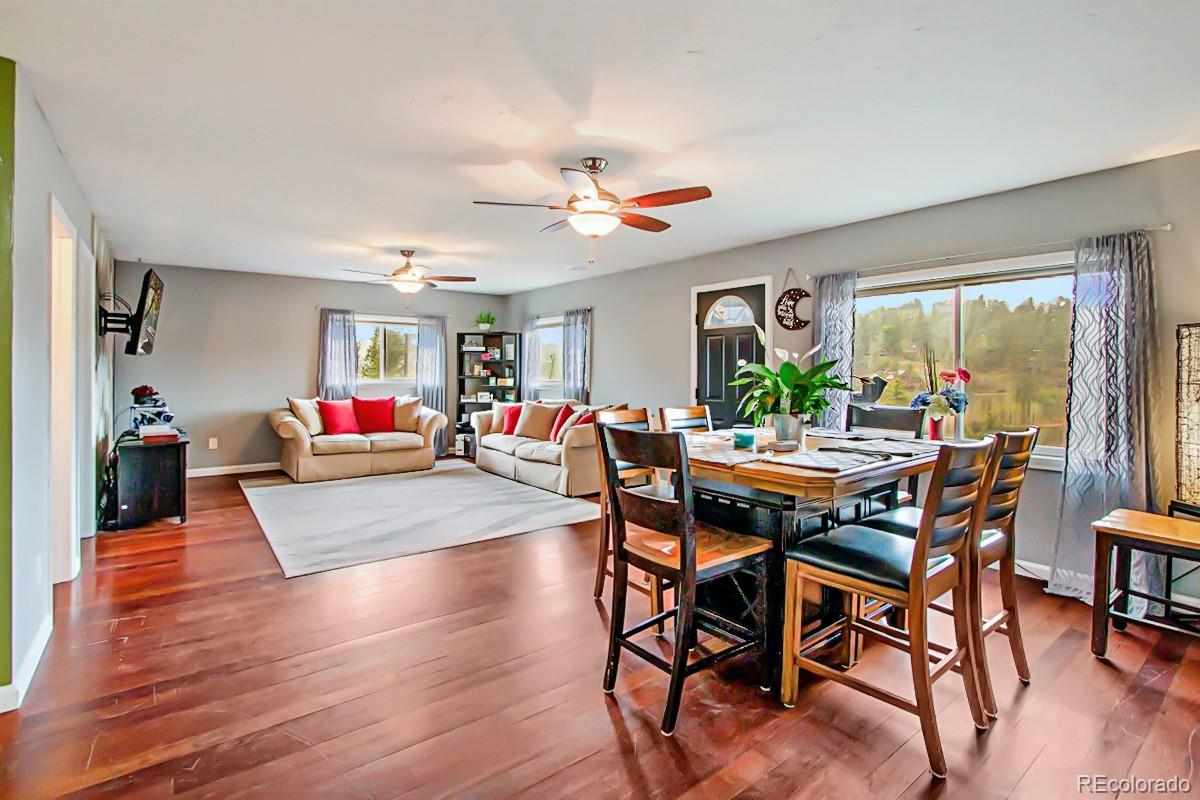 191 Renaud Road Bailey, CO 80421 - Photo 7 of 28 a view of a dining room with furniture window and wooden floor