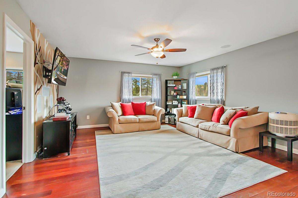 191 Renaud Road Bailey, CO 80421 - Photo 8 of 28 a living room with furniture a flat screen tv and a window
