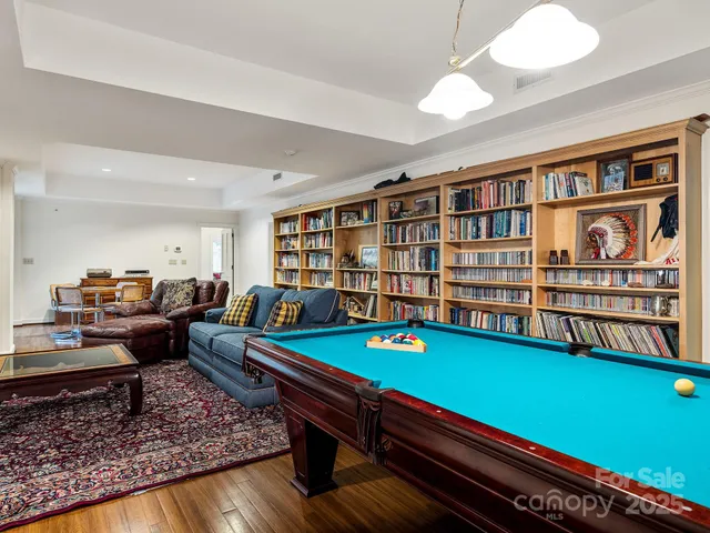 a living room with furniture and a book shelf