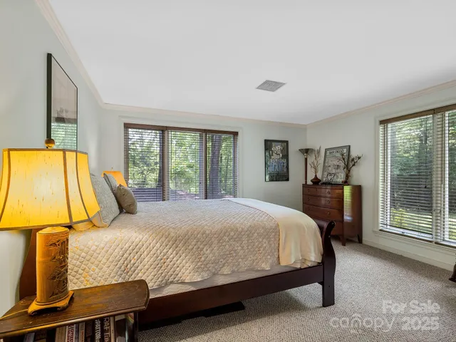 a bedroom with a bed and glass door